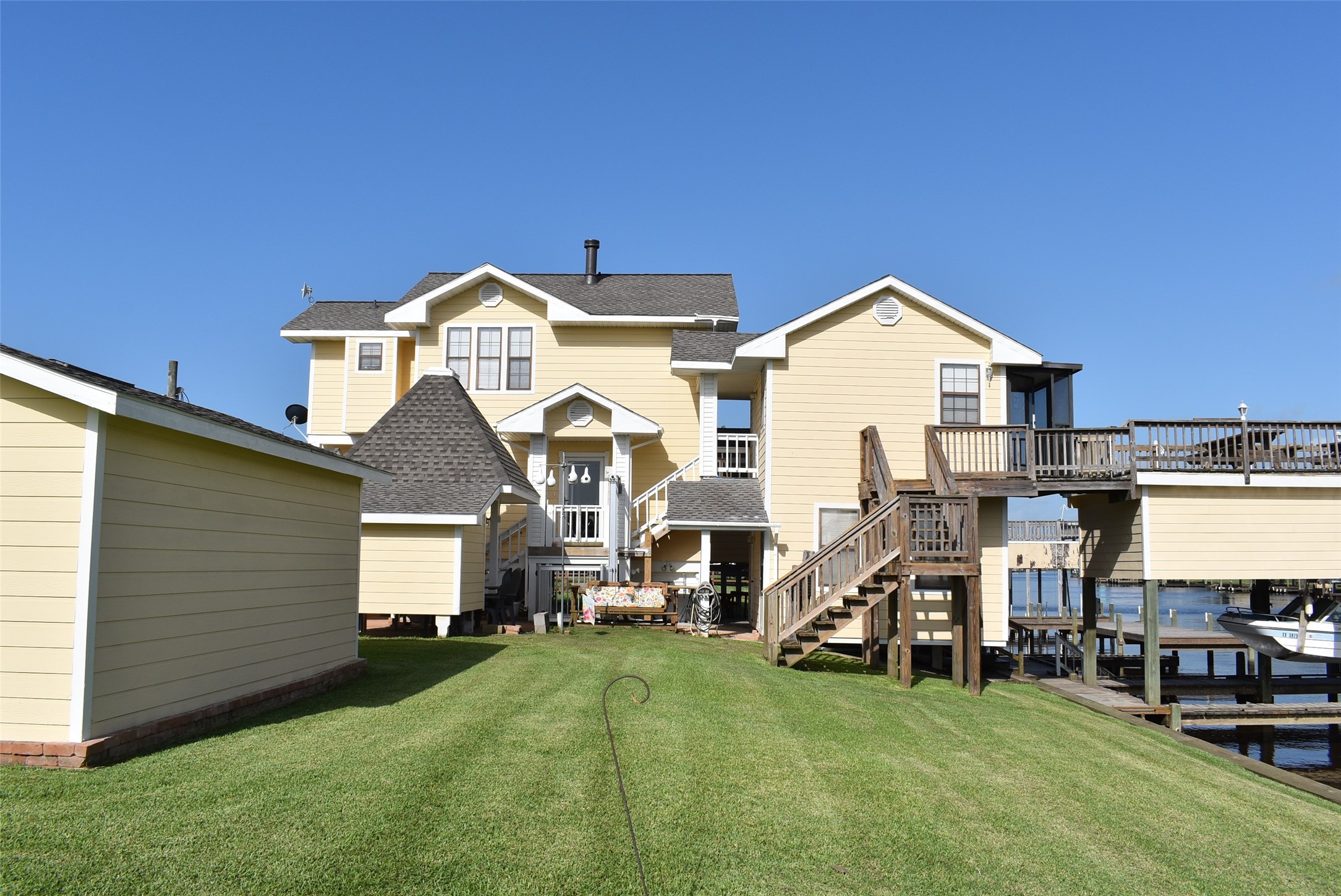 1657 County Road Sargent, TX 77414 - Photo 2 of 50 a view of a house with a big yard and large trees