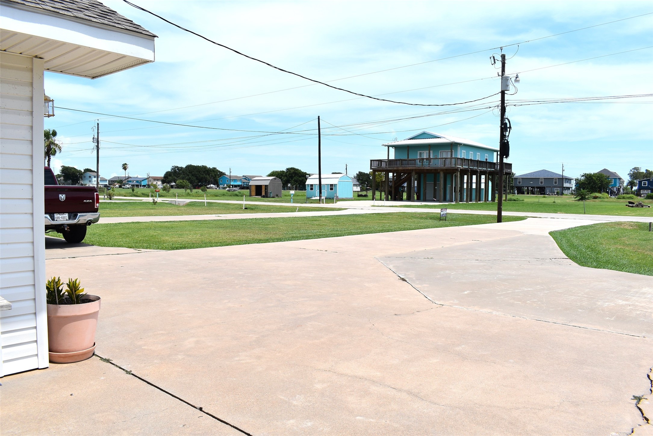 1657 County Road Sargent, TX 77414 - Photo 42 of 50 a view of a road with a big yard and potted plants