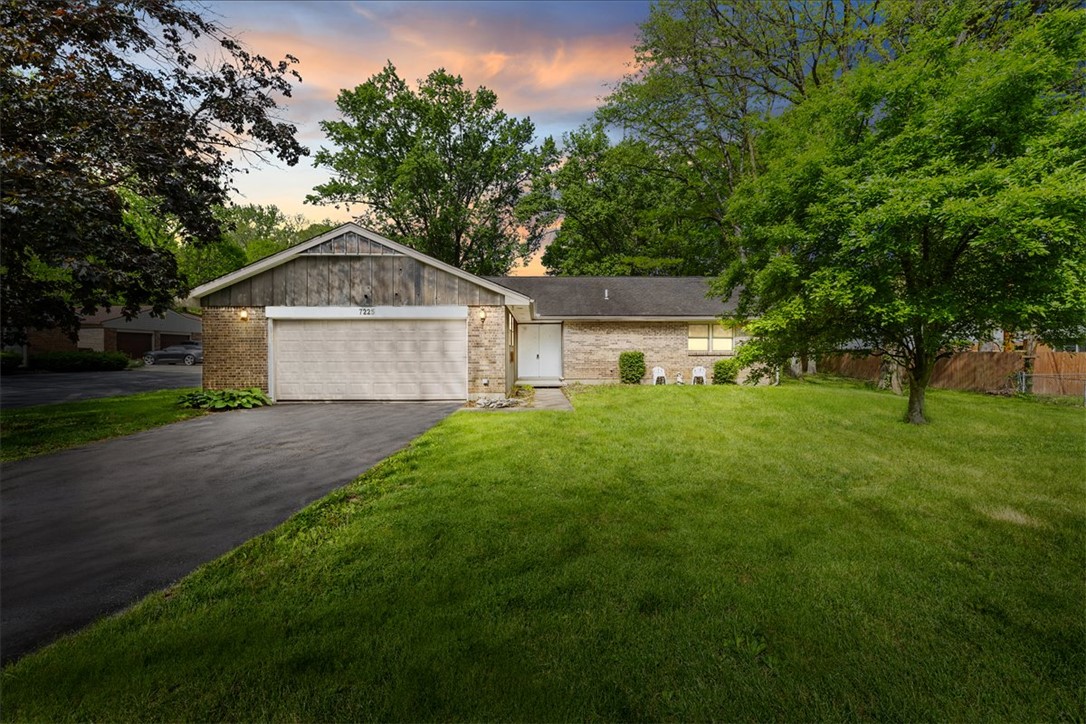 7225 Garber Road Clayton, OH 45415 - Photo 33 of 33 This charming residence features a classic brick exterior and a lush green lawn.