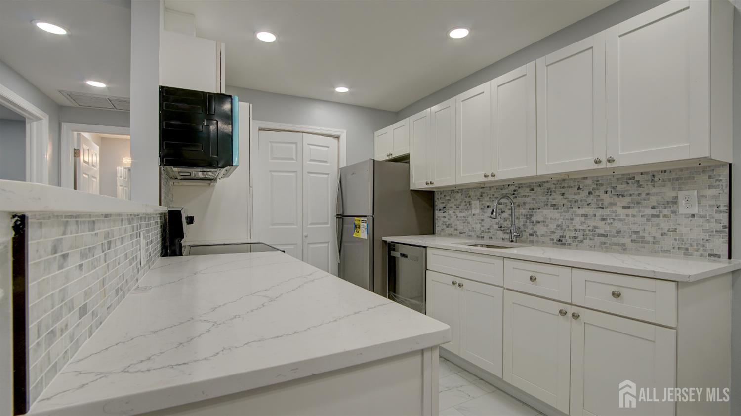 146 B Old Nassau Road Monroe Township, NJ 08831 - Photo 13 of 46 a kitchen with a sink stainless steel appliances and cabinets