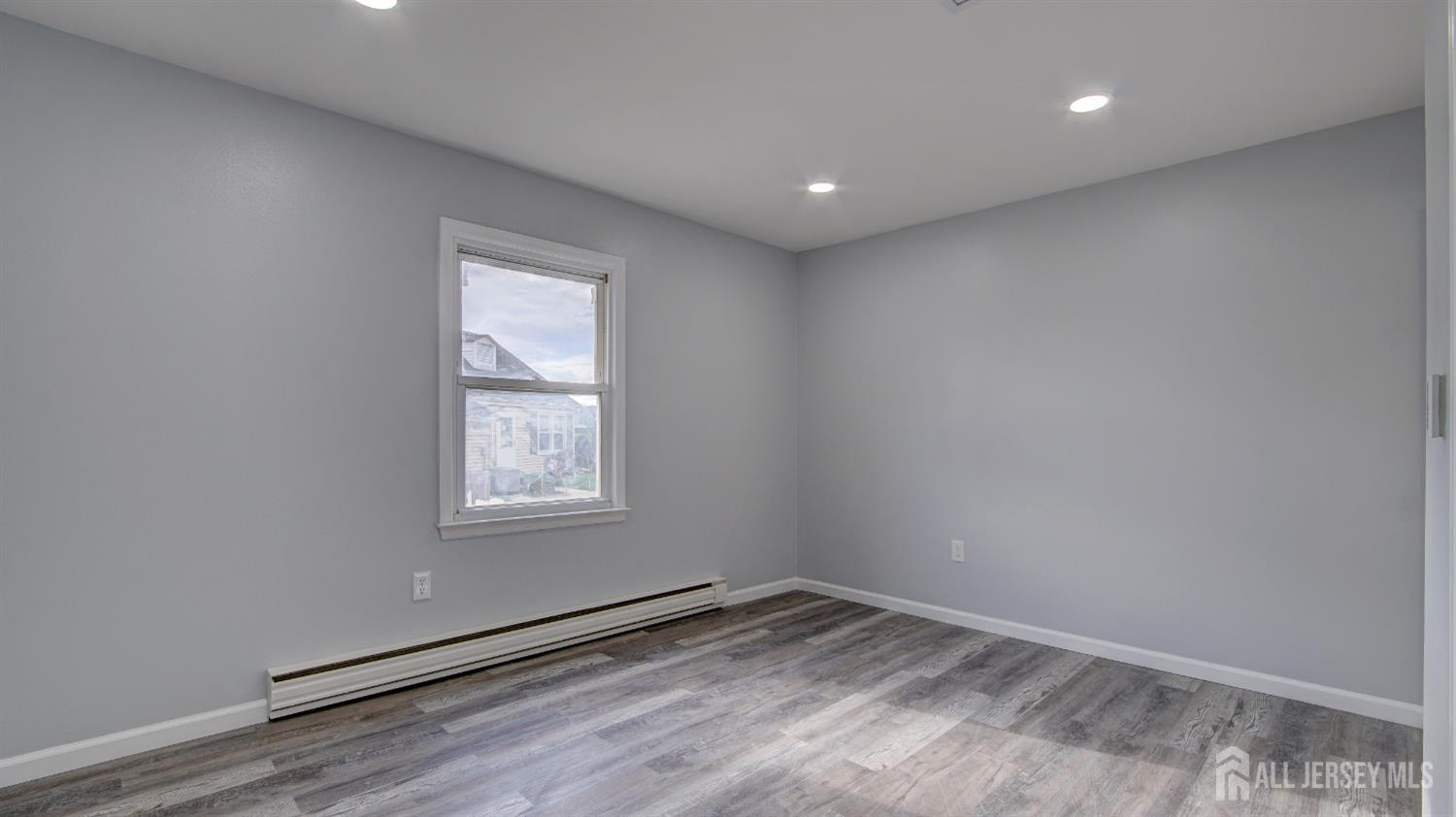 146 B Old Nassau Road Monroe Township, NJ 08831 - Photo 22 of 46 an empty room with wooden floor and windows