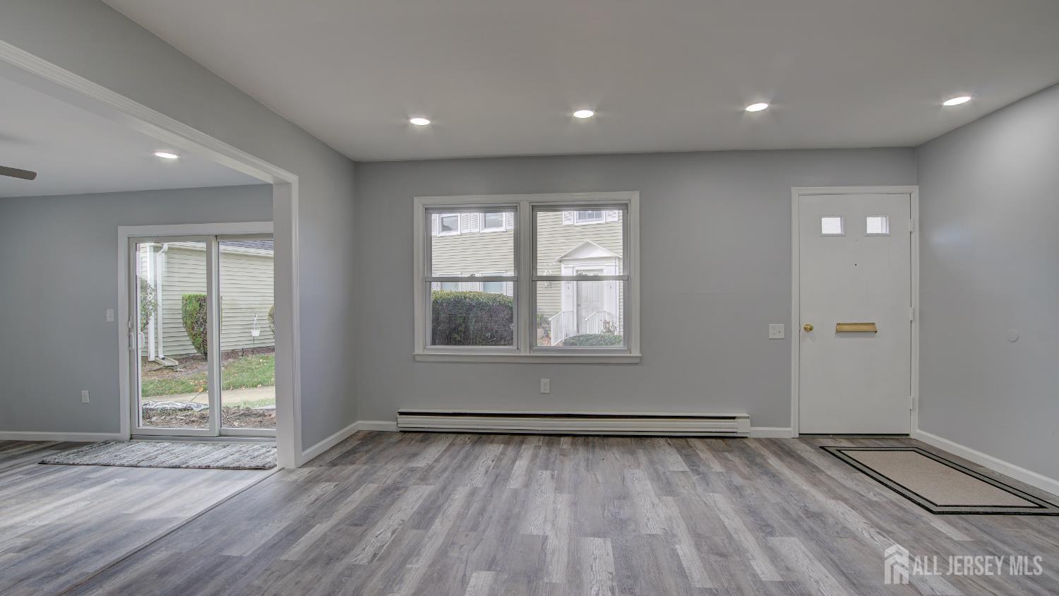 146 B Old Nassau Road Monroe Township, NJ 08831 - Photo 4 of 46 an empty room with wooden floor and windows