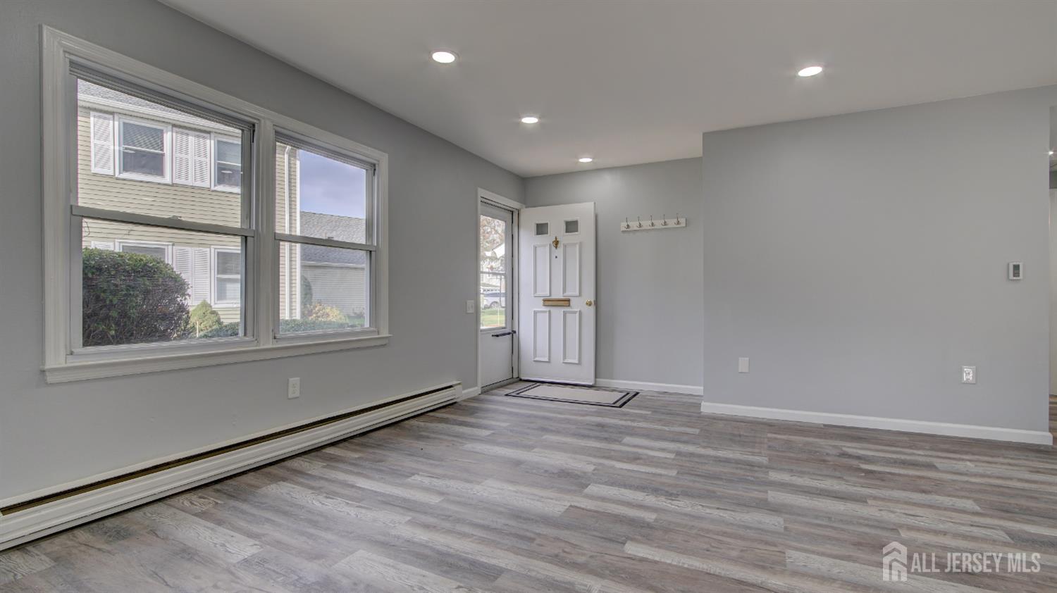 146 B Old Nassau Road Monroe Township, NJ 08831 - Photo 6 of 46 a view of an empty room with wooden floor and a window