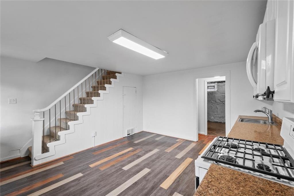 2012 Spring Street Pittsburgh, PA 15210 - Photo 14 of 20 a bedroom with a bed and wooden floor