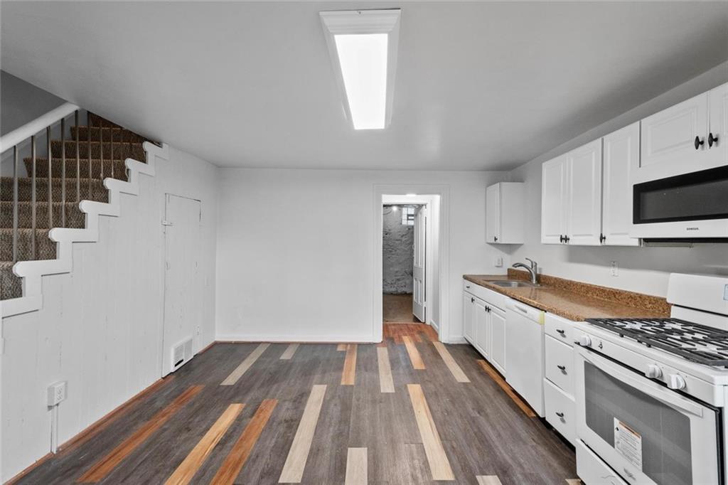 2012 Spring Street Pittsburgh, PA 15210 - Photo 15 of 20 a kitchen with wooden floor and electronic appliances