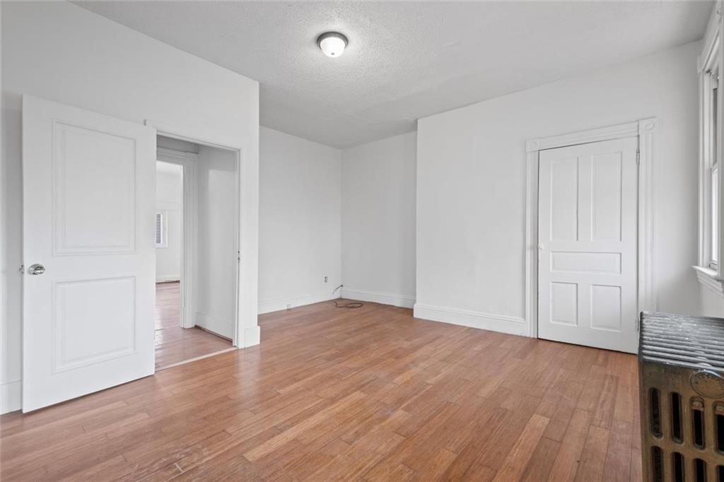 2012 Spring Street Pittsburgh, PA 15210 - Photo 17 of 20 a view of an empty room with wooden floor