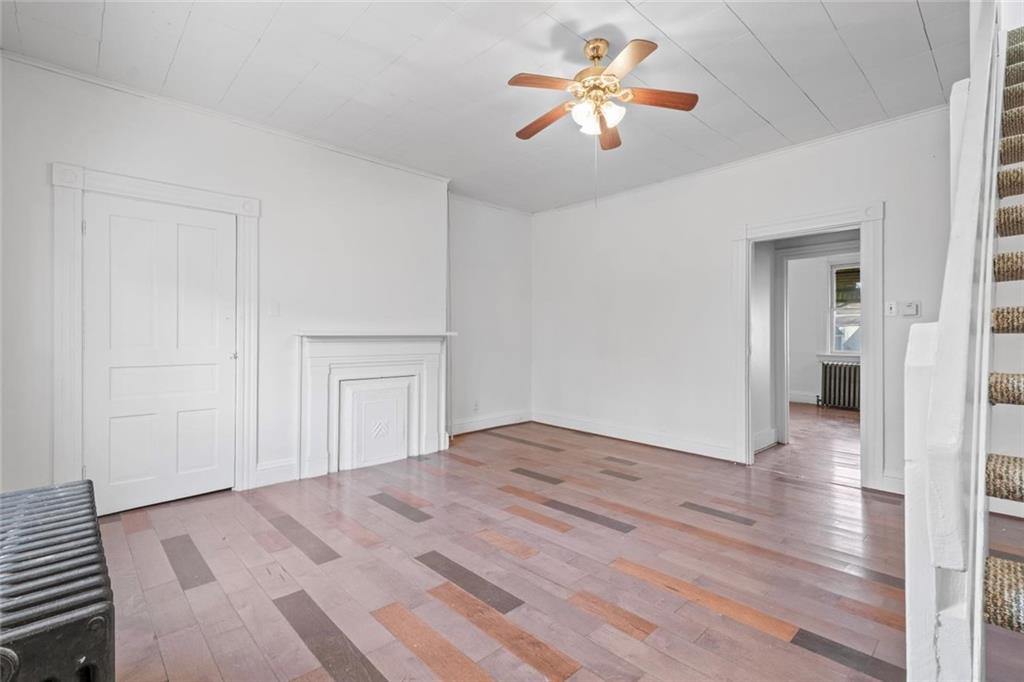 2012 Spring Street Pittsburgh, PA 15210 - Photo 18 of 20 a view of empty room with wooden floor and fan