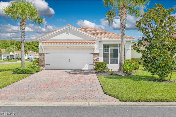 a view of a house with a yard and plants