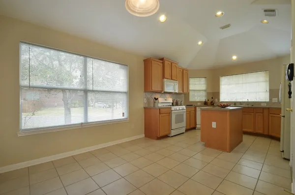 a view of a kitchen with furniture and an empty room