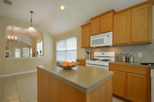 a kitchen with stainless steel appliances a stove a sink a refrigerator and cabinets