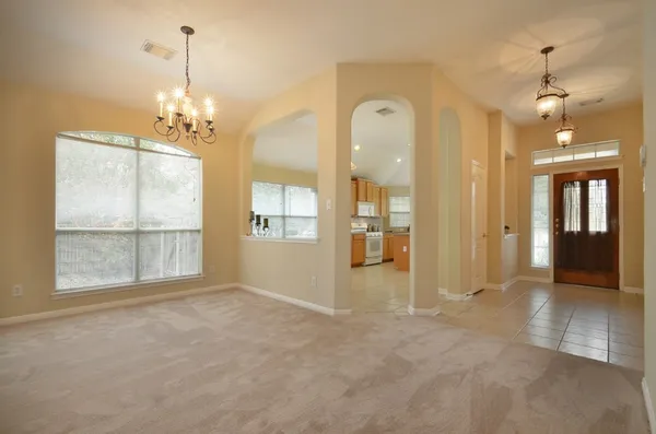 a view of a room with wooden floor and windows