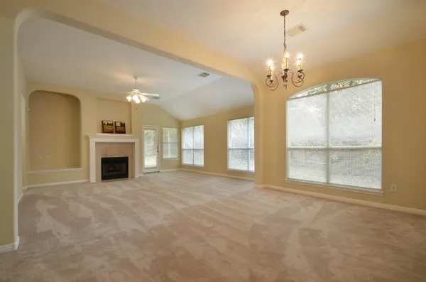 a view of a livingroom with a chandelier and fireplace