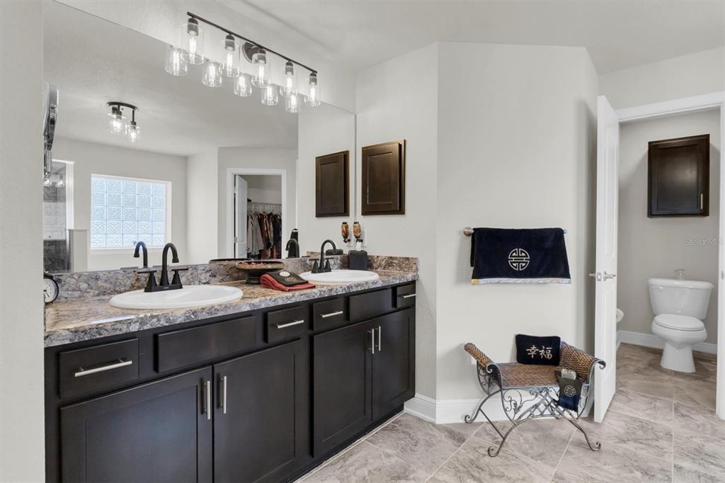 3455 Whispy Court Spring Hill, FL 34609 - Photo 11 of 42 a spacious bathroom with a sink a mirror and a toilet