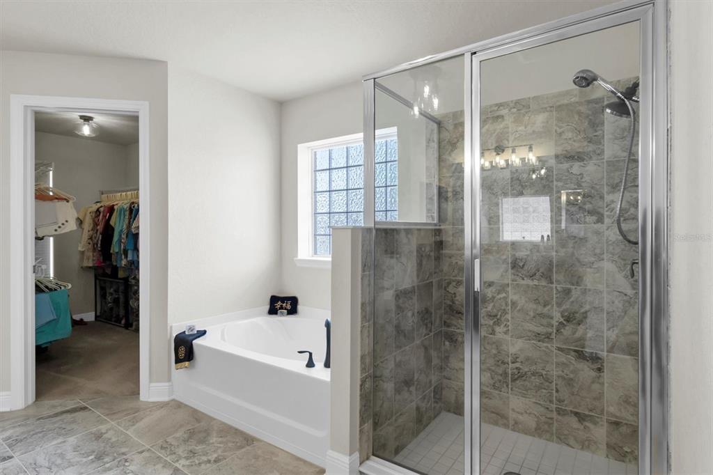 3455 Whispy Court Spring Hill, FL 34609 - Photo 12 of 42 a bathroom with a bathtub and a shower