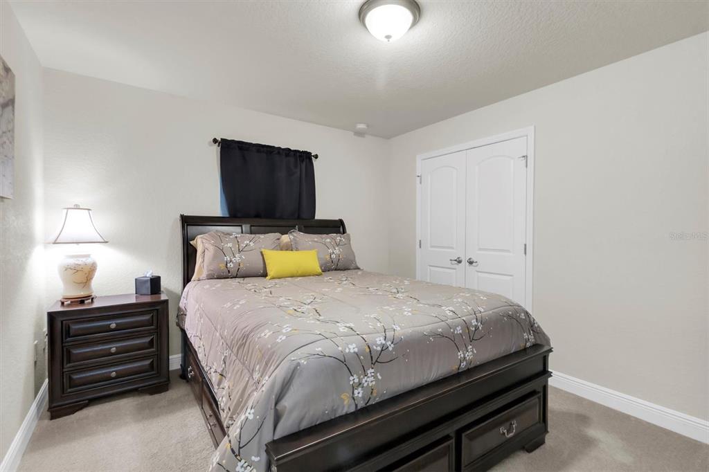 3455 Whispy Court Spring Hill, FL 34609 - Photo 13 of 42 a bedroom with a bed and a tv