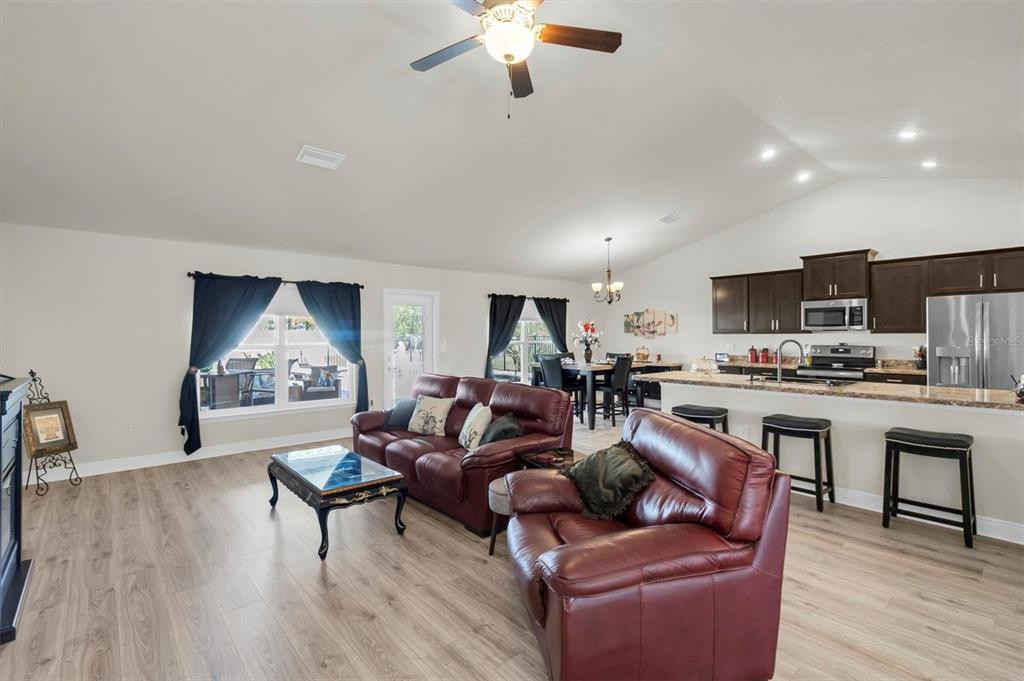 3455 Whispy Court Spring Hill, FL 34609 - Photo 17 of 42 a living room with furniture kitchen view and a wooden floor