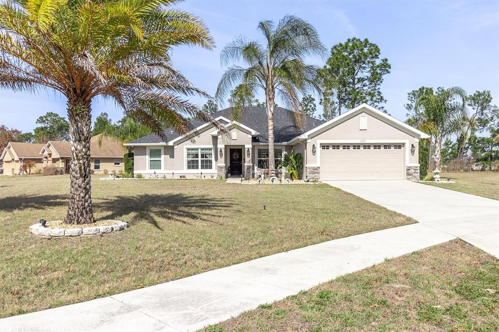 3455 Whispy Court Spring Hill, FL 34609 - Photo 2 of 42 a front view of a house with a yard