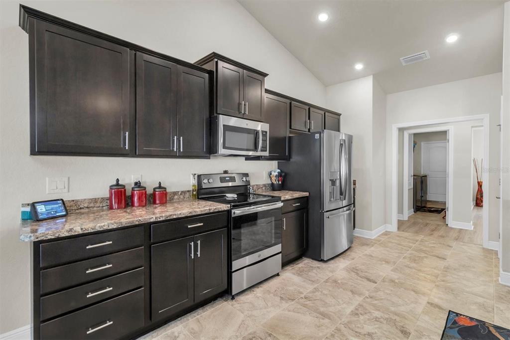 3455 Whispy Court Spring Hill, FL 34609 - Photo 22 of 42 a kitchen with a refrigerator sink and microwave