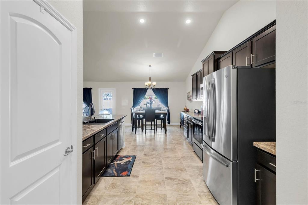 3455 Whispy Court Spring Hill, FL 34609 - Photo 24 of 42 a kitchen with stainless steel appliances granite countertop a refrigerator and a stove