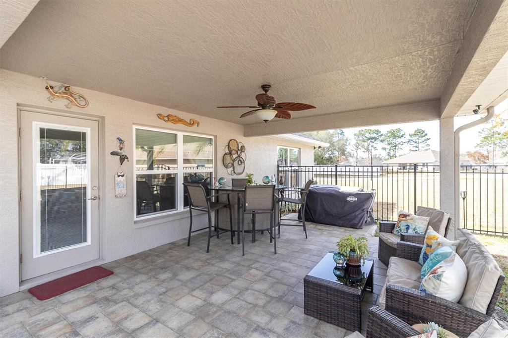 3455 Whispy Court Spring Hill, FL 34609 - Photo 26 of 42 a living room with furniture and large windows