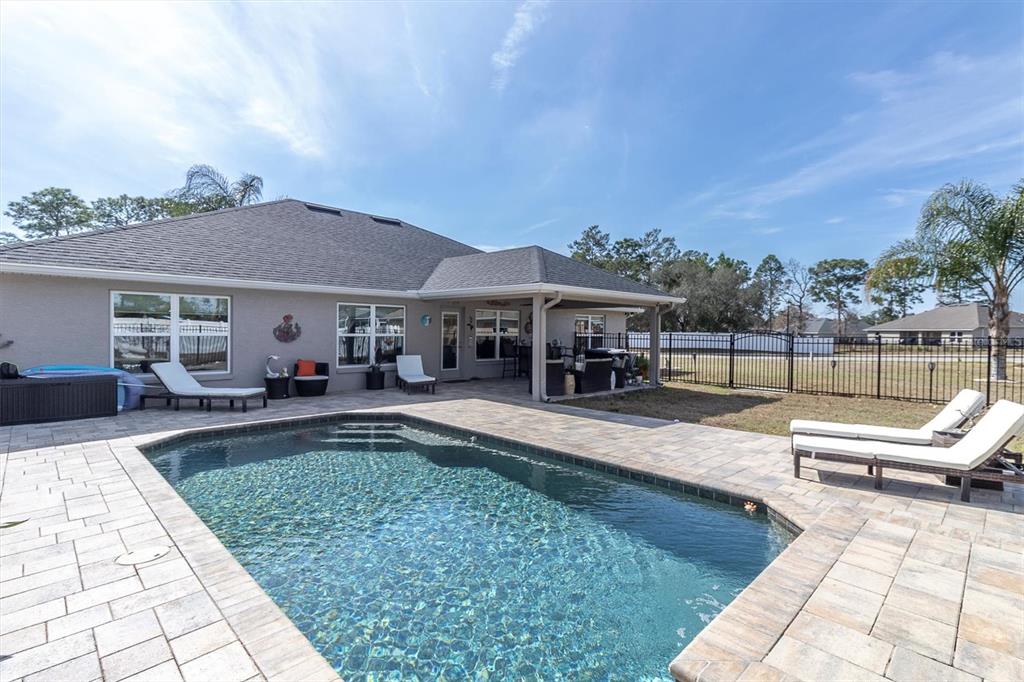 3455 Whispy Court Spring Hill, FL 34609 - Photo 29 of 42 swimming pool view with a seating space and a garden view