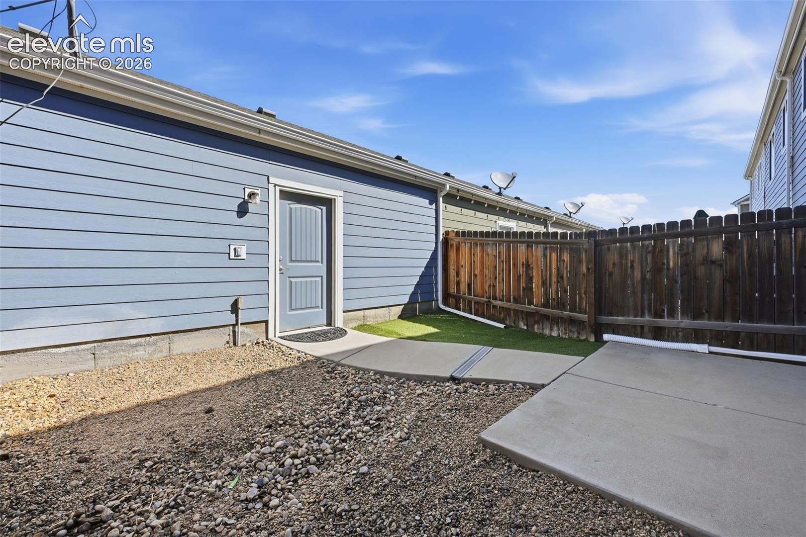 6306 Pilgrimage Road Colorado Springs, CO 80925 - Photo 31 of 37 private yard with garage entrance