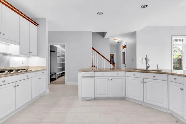 a kitchen with sink stove and cabinets