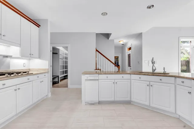 a kitchen with sink stove and cabinets