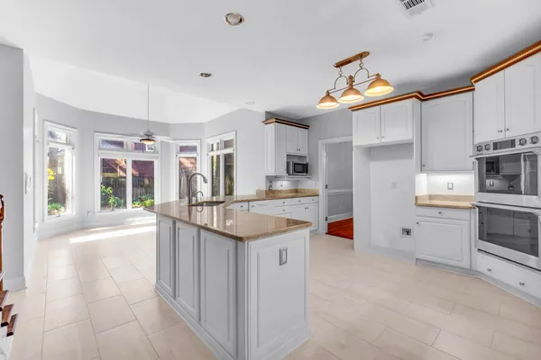 a kitchen with stainless steel appliances granite countertop a sink and cabinets
