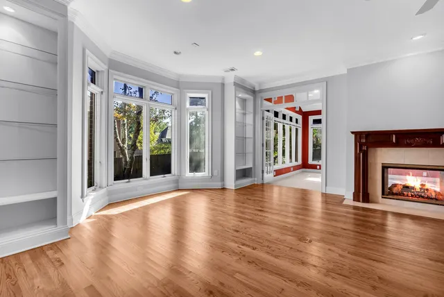 a view of an empty room with window and fire place