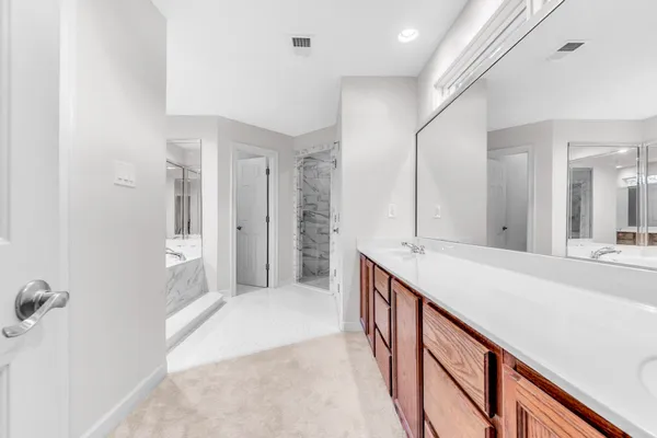 a bathroom with a double vanity sink and mirror