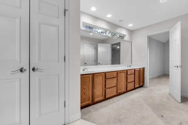 a spacious bathroom with a double vanity sink and a mirror