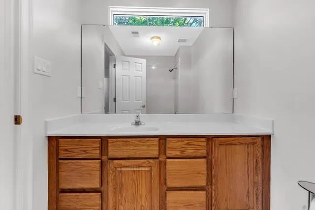 a bathroom with a sink a mirror and a window