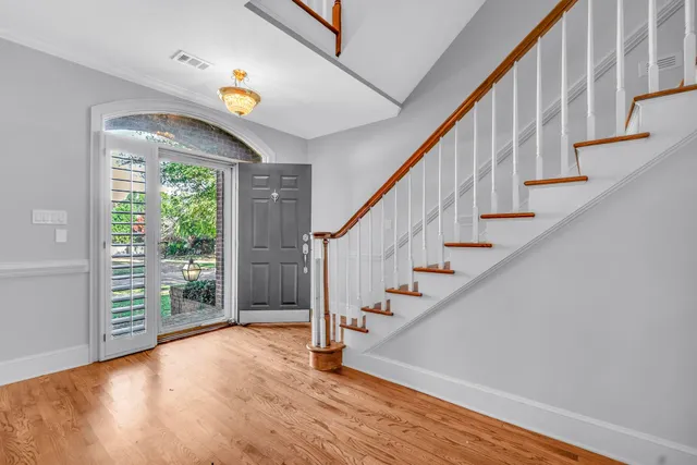 a view of entryway with wooden floor and stairs