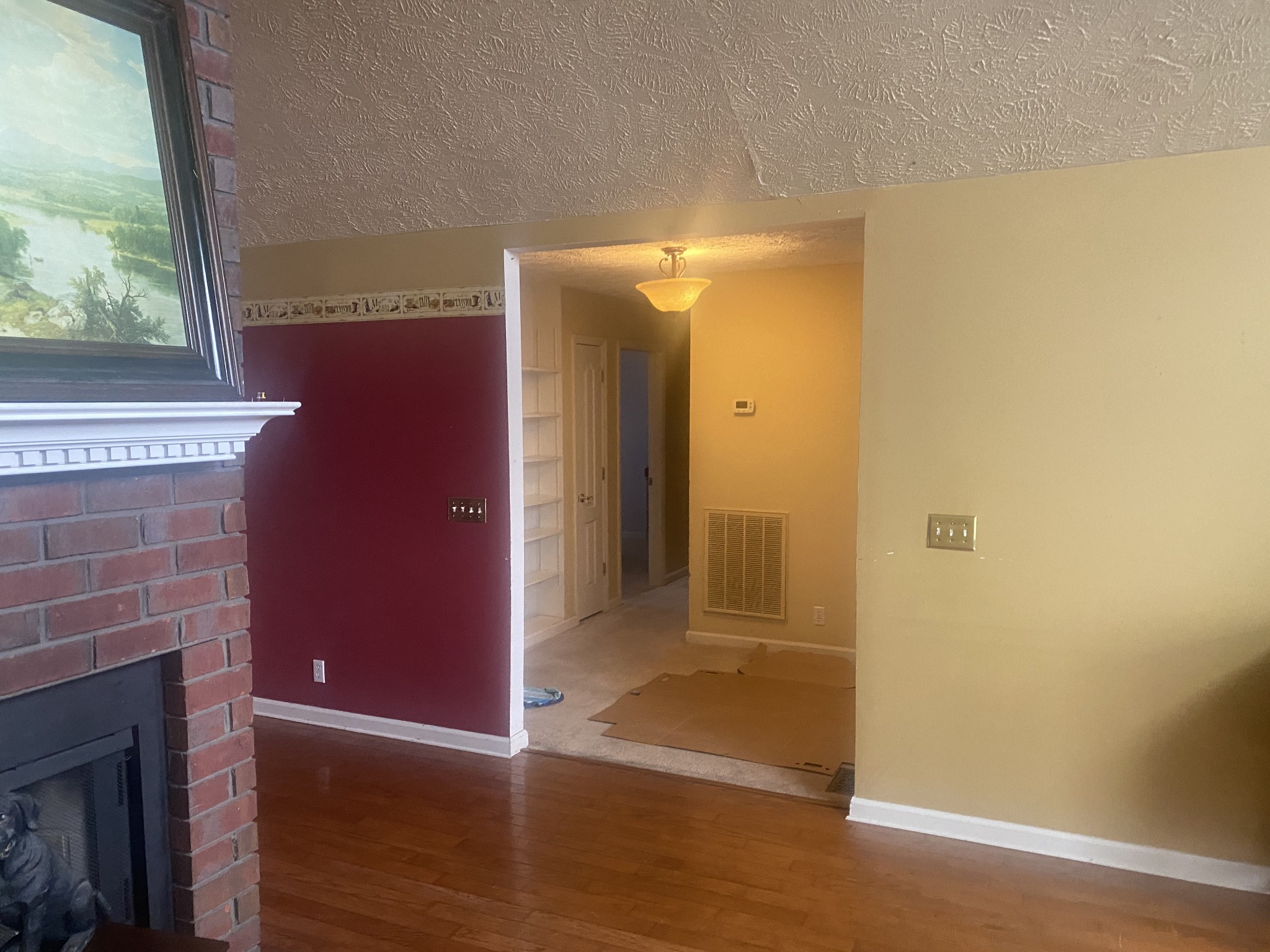 113 Lake Wood Road Lebanon, TN 37087 - Photo 10 of 19 a view of a hallway with wooden floor and a fireplace