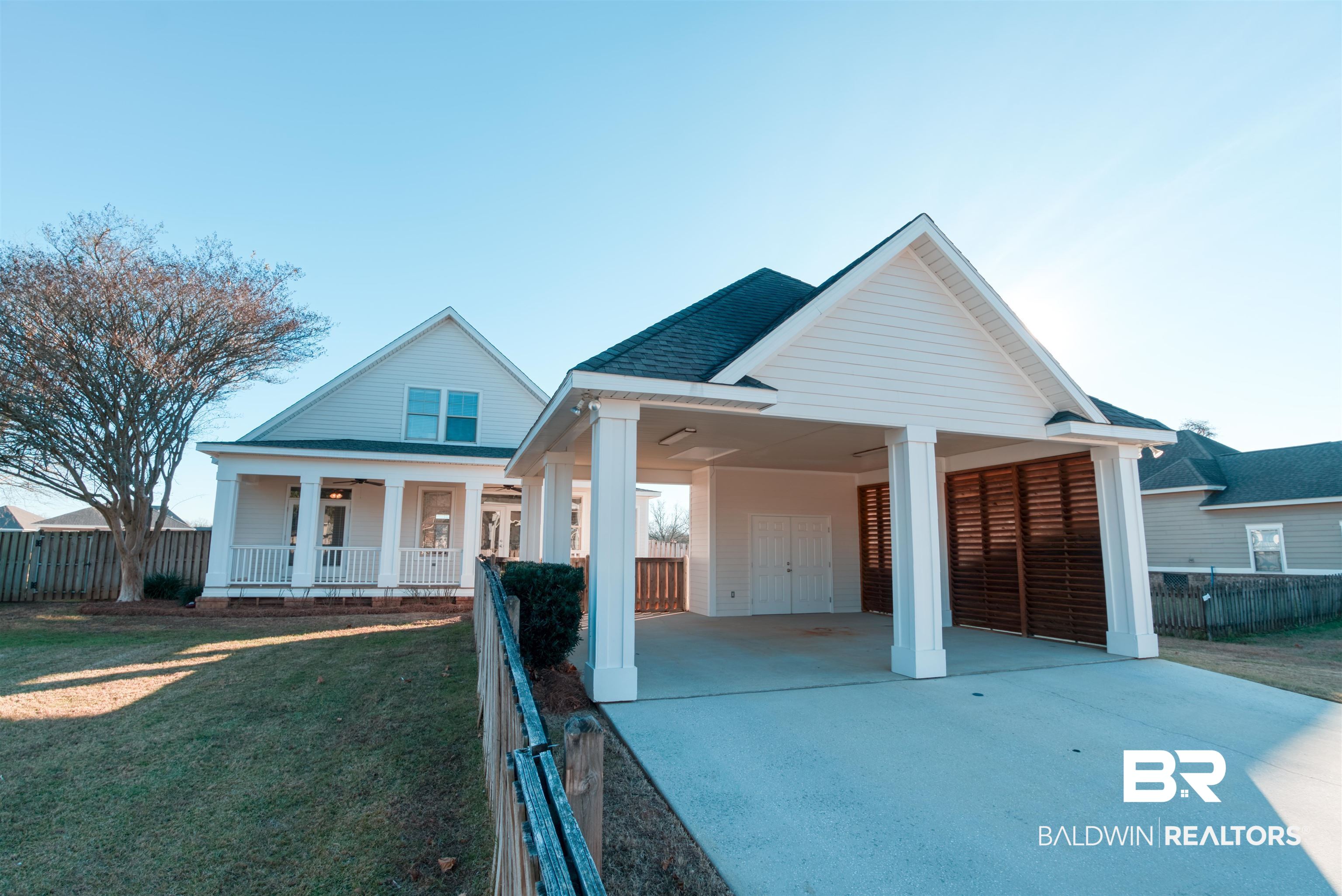 24561 Austin Road Daphne, AL 36526 - Photo 44 of 57 View of front of home featuring a carport, a porch, and a front lawn