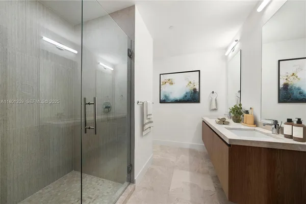 a bathroom with a shower sink and mirror