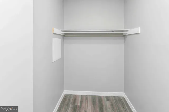 a view of a room with a window and a ceiling fan