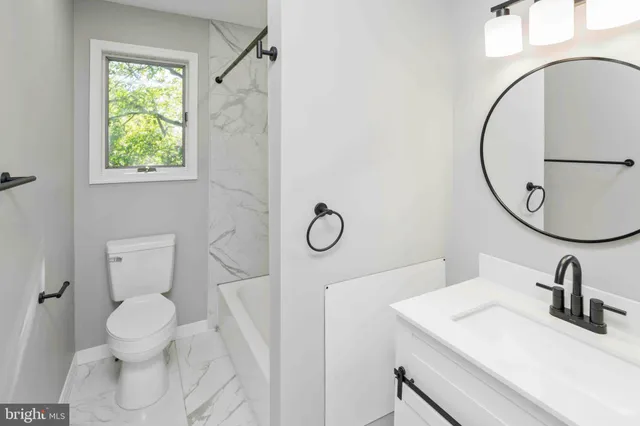 a large kitchen with stainless steel appliances granite countertop a lot of counter space and wooden floor