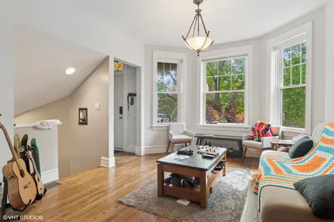 a living room with furniture and floor to ceiling windows
