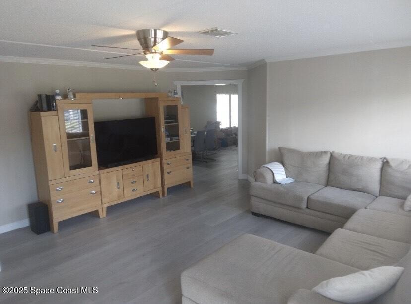 7013 Fern Drive Cocoa, FL 32927 - Photo 2 of 4 a living room with furniture and a flat screen tv