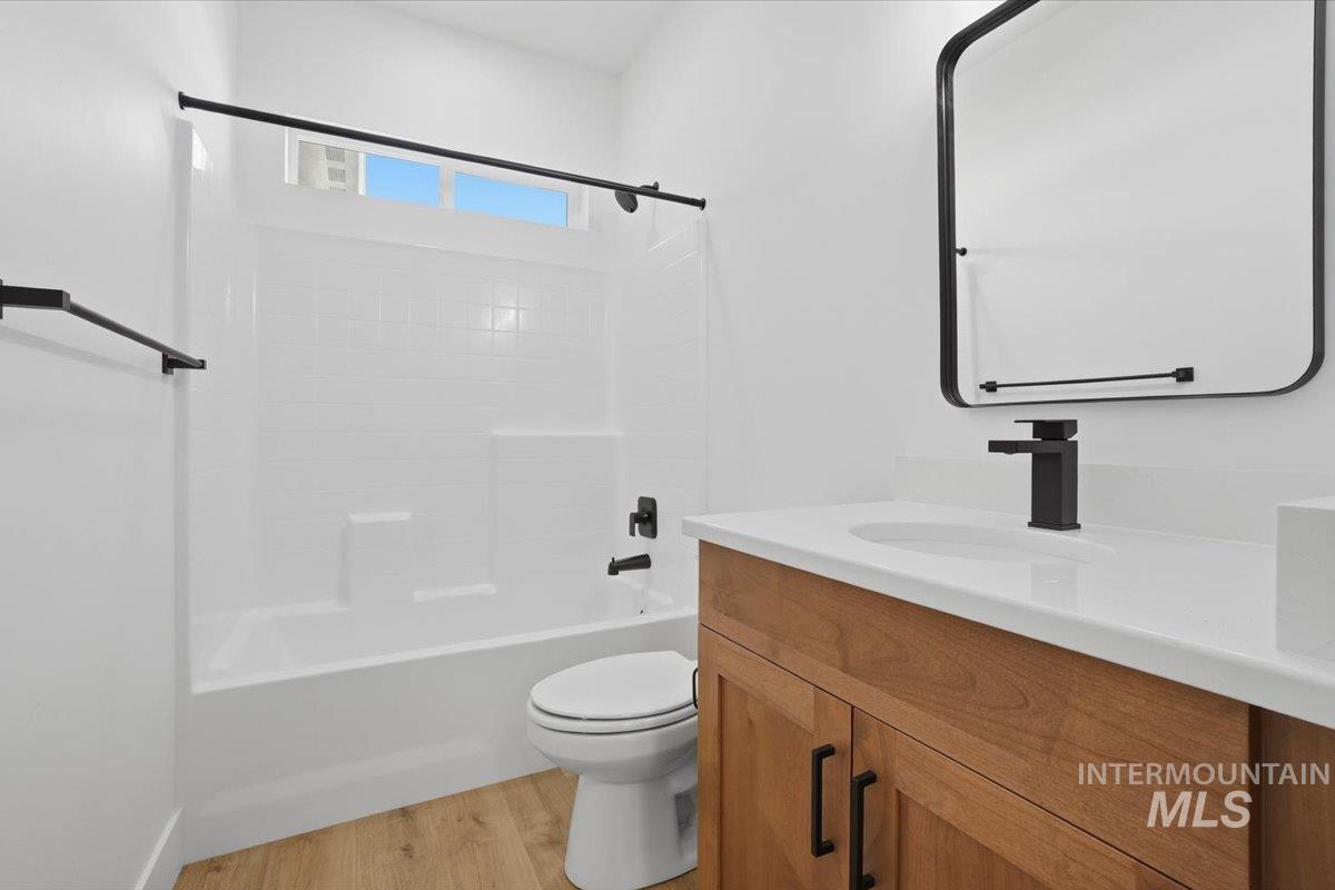 2175 Austin Way Fruitland, ID 83619 - Photo 13 of 30 Full bath featuring vanity, light wood finished floors, and washtub / shower combination