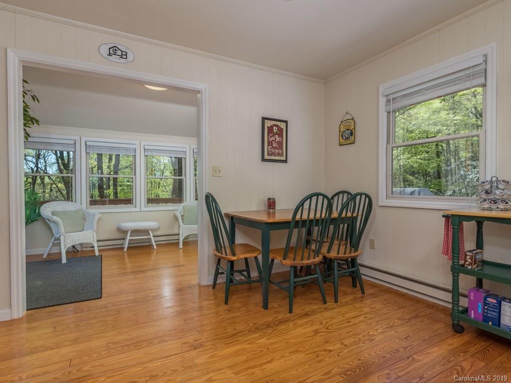 1251 Judes Gap Road Mill Spring, NC 28756 - Photo 11 of 35 a view of a dining room with furniture window and wooden floor