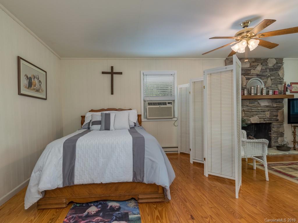 1251 Judes Gap Road Mill Spring, NC 28756 - Photo 17 of 35 a bed room with a bed and a television