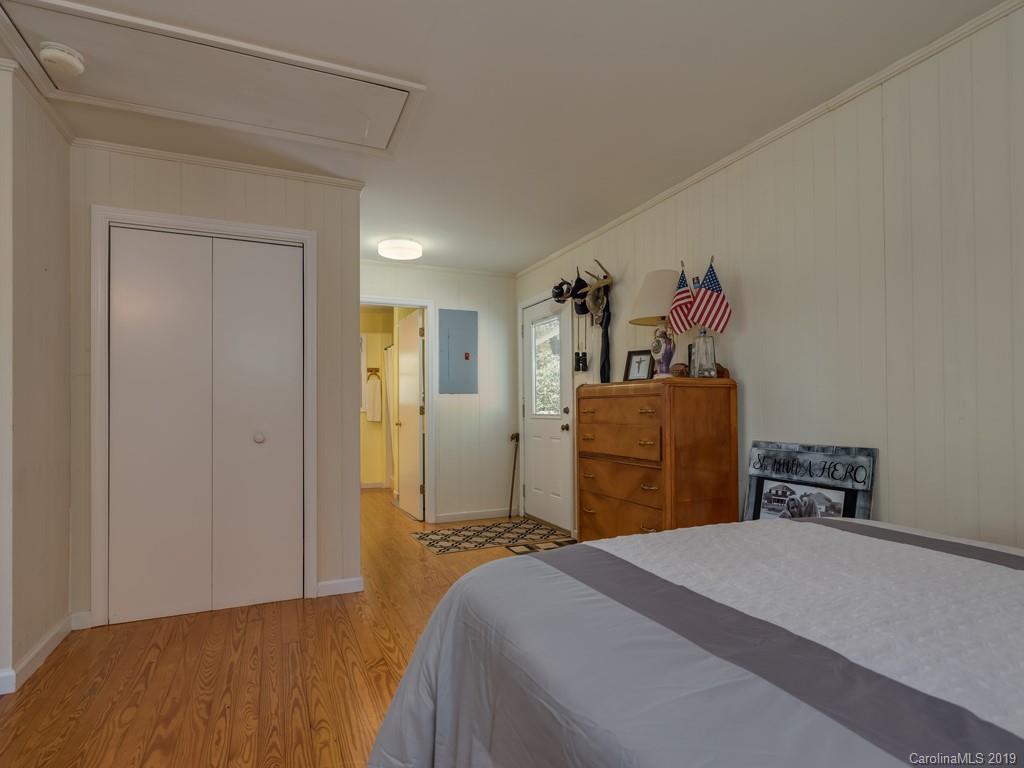 1251 Judes Gap Road Mill Spring, NC 28756 - Photo 18 of 35 a bedroom with a bed and a sink