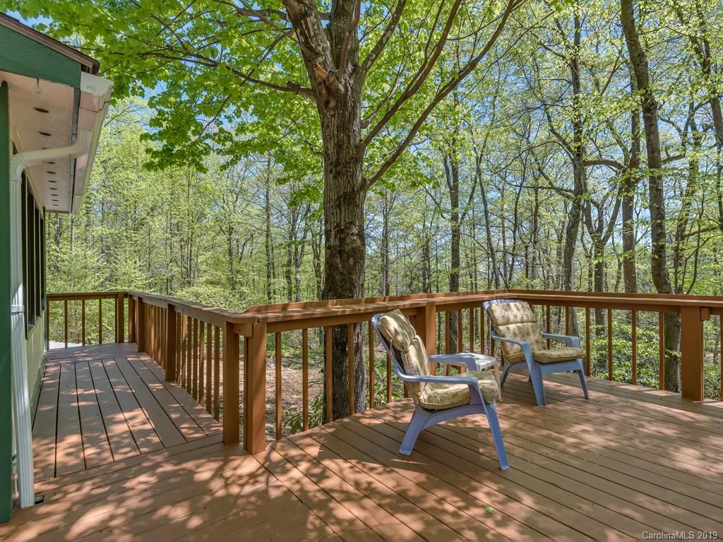 1251 Judes Gap Road Mill Spring, NC 28756 - Photo 20 of 35 a view of a balcony with chairs and wooden fence