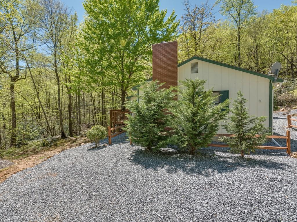 1251 Judes Gap Road Mill Spring, NC 28756 - Photo 3 of 35 a backyard of a house with lots of green space