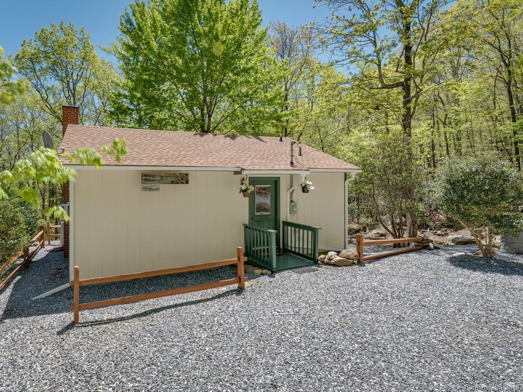 1251 Judes Gap Road Mill Spring, NC 28756 - Photo 4 of 35 a view of a house with a yard and garage