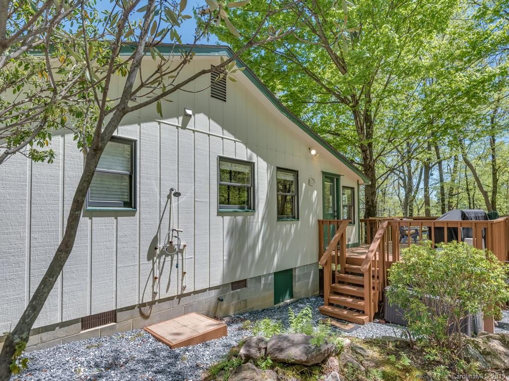 1251 Judes Gap Road Mill Spring, NC 28756 - Photo 5 of 35 a backyard of a house with barbeque oven table and chairs