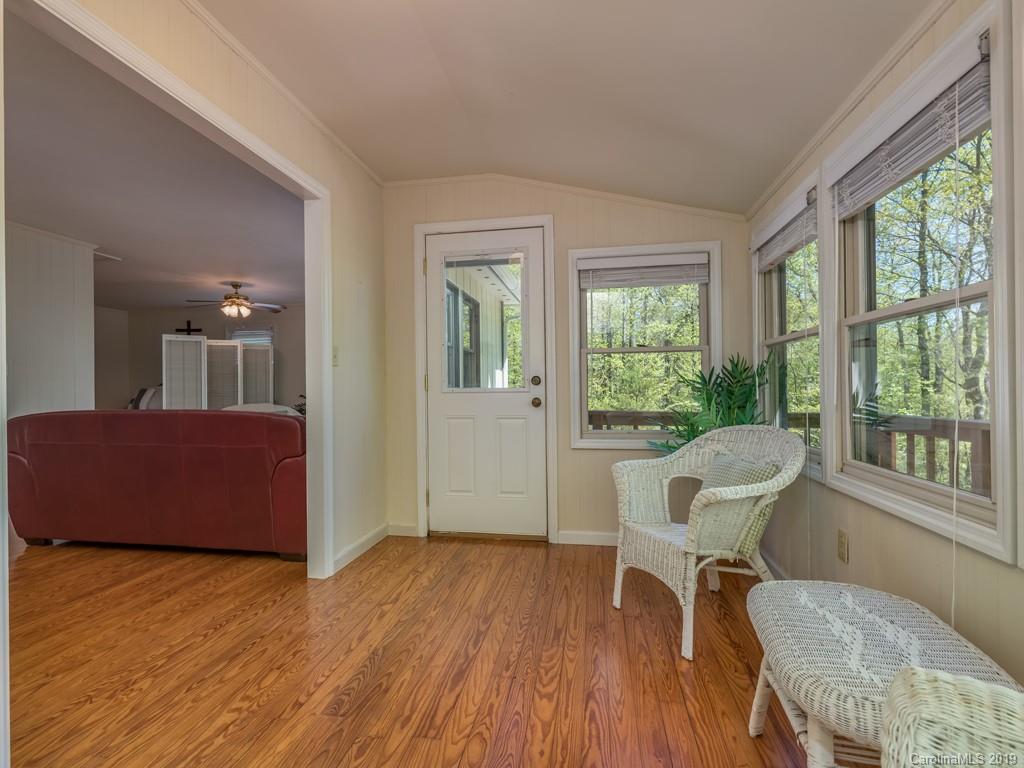1251 Judes Gap Road Mill Spring, NC 28756 - Photo 8 of 35 a view of a livingroom with furniture window and wooden floor